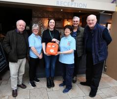 Handing over a new defibrillator for use at the Ardencaple Hotel, Rhu.